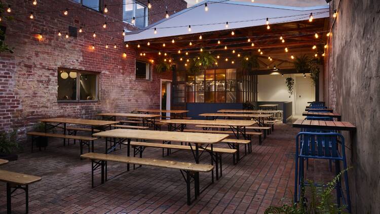 Molly Rose Brewery's lit-up beer garden at dusk.