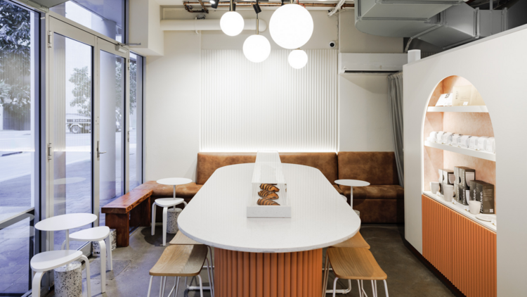 A white marble and orange timber cafe interior