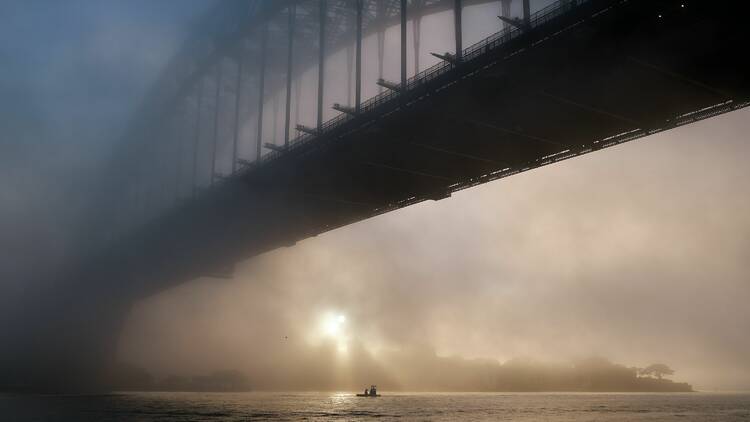 The Sydney Harbour Bridge clouded by fog