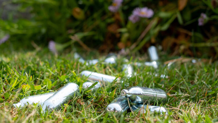 Laughing gas canisters discarded on the grass