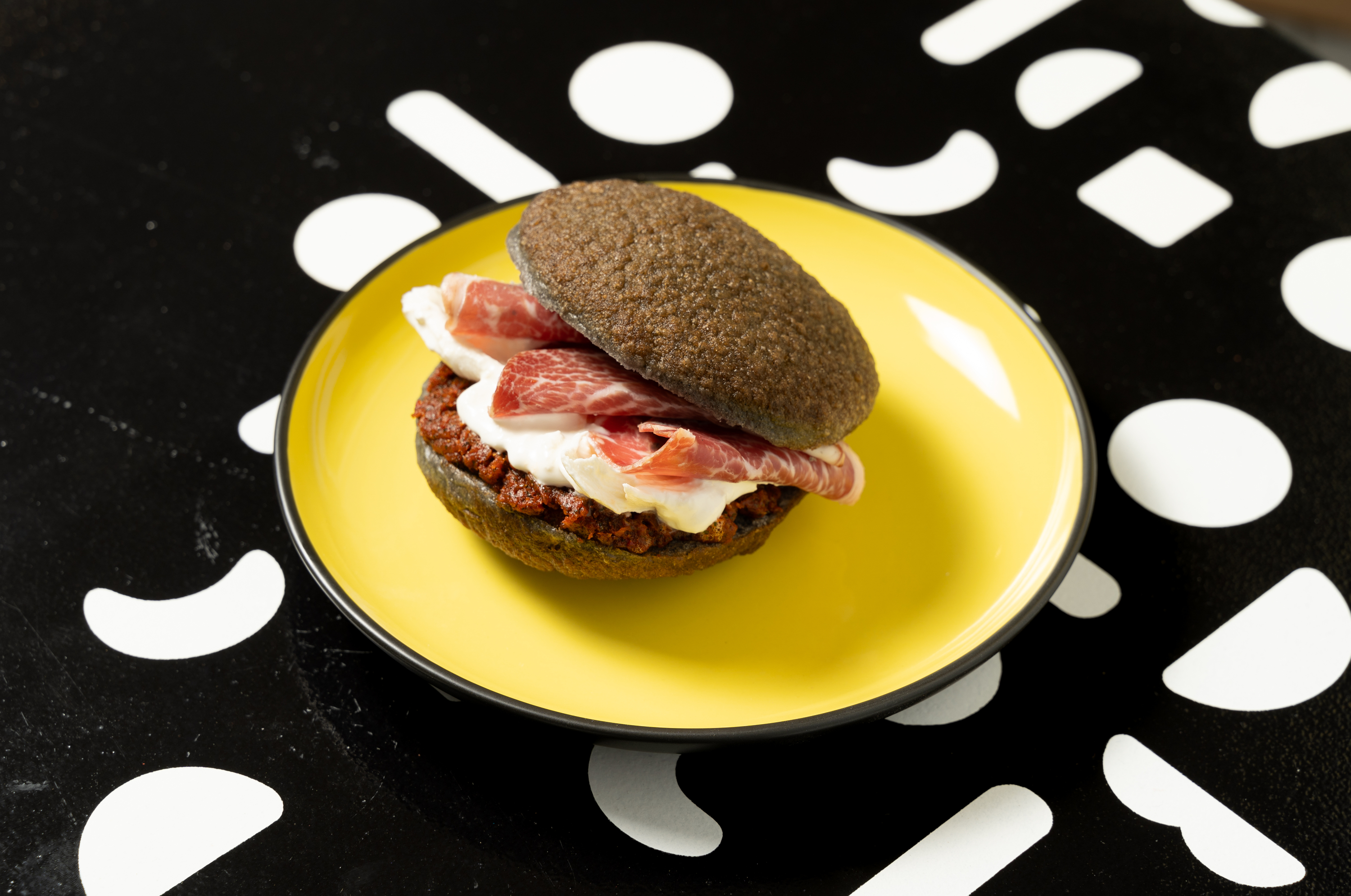 Bombolone grano arso with capicollo, burrata and sun-dried tomato paste at Unregular Bakery