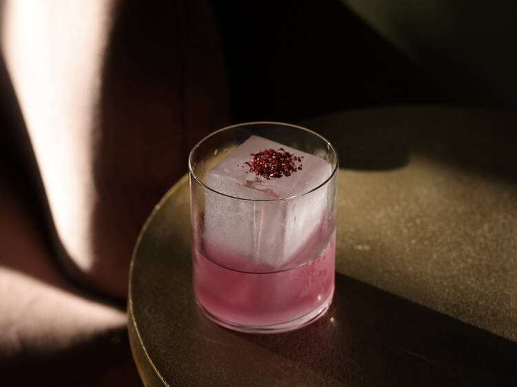 A pink cocktail on a table.