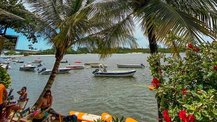 Try stand-up paddleboarding in Guaratiba