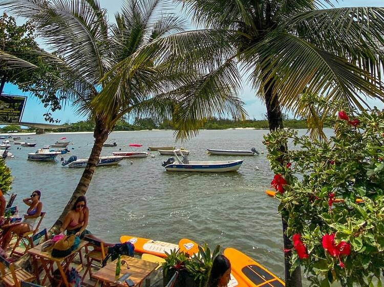 Try stand-up paddleboarding in Guaratiba