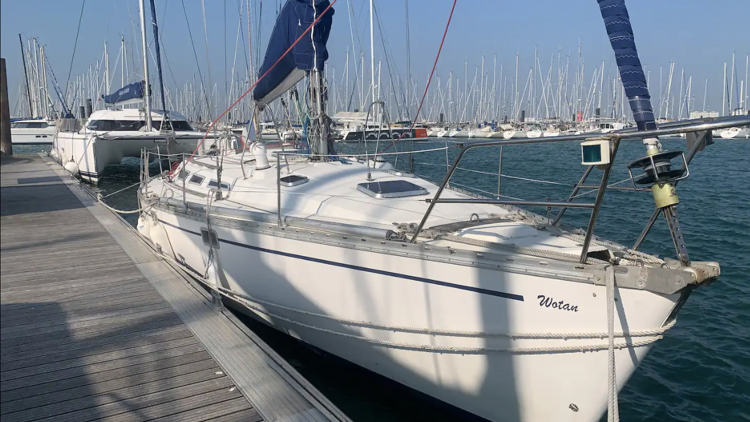 A luxurious port sailboat anchored in the old harbour area