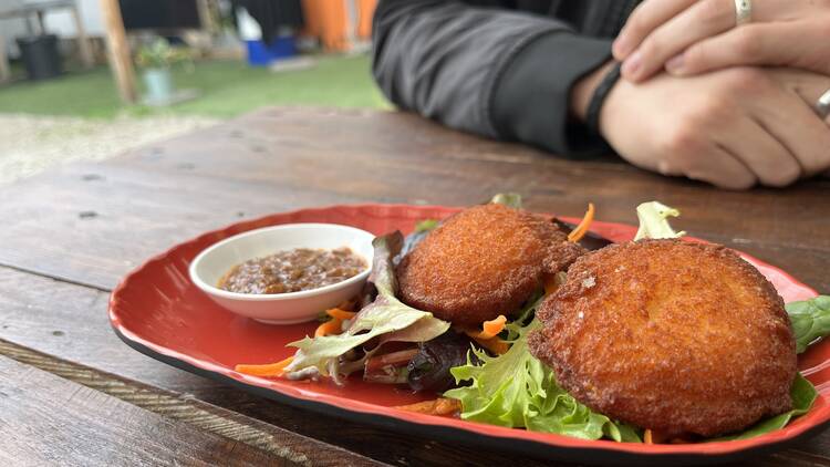 Akra fritters with chilli sauce.