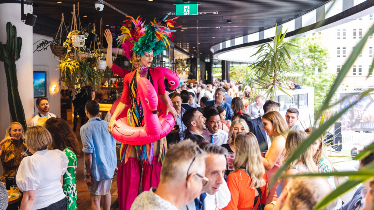 A flamingo person on stilts