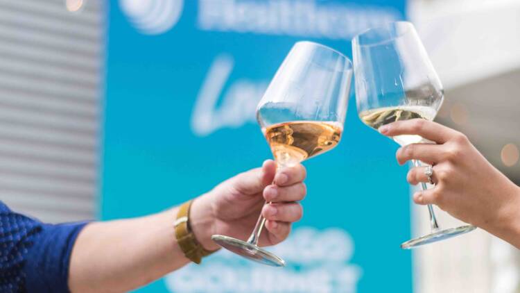 Two people cheersing with wine glasses