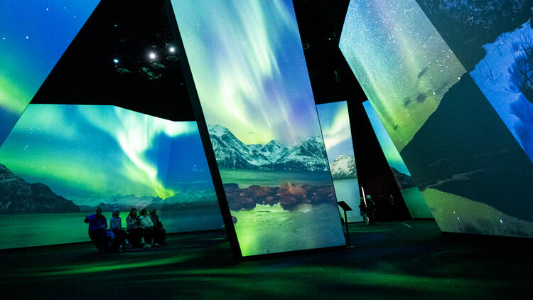 Huge screens display the northern lights. 