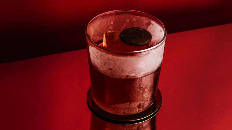 a Negroni on a red backdrop