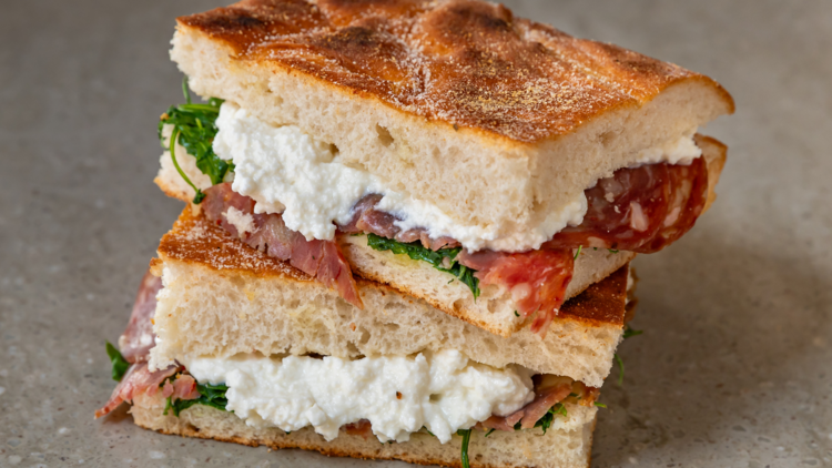 A focaccia sandwich with mozzarella and salami