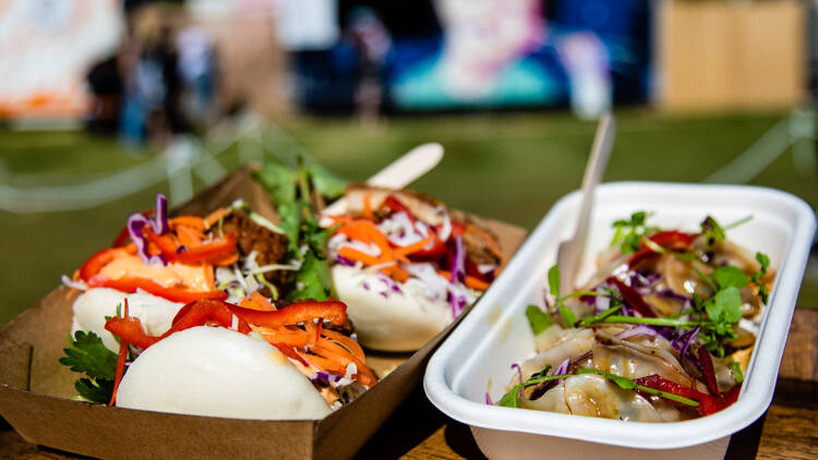 Assorted containers of bao and dumplings.