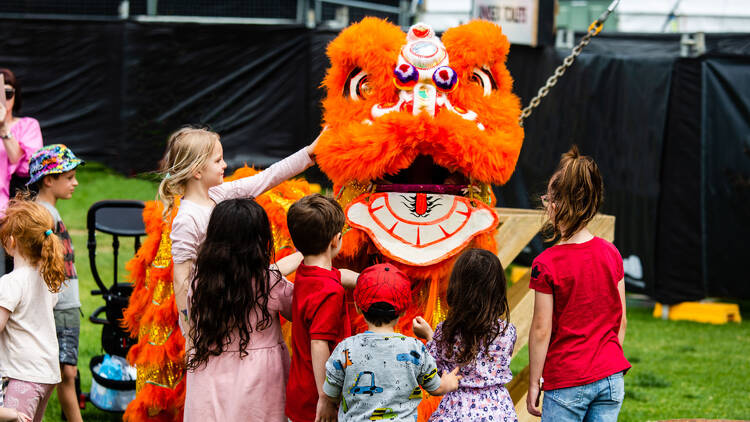 Children playing with a costumed performer.