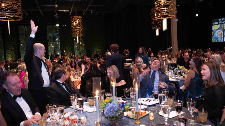 Guests at a gala seated around a table