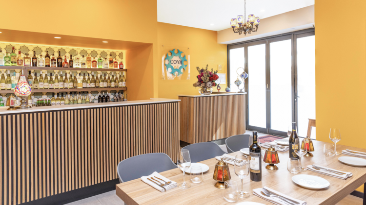 A yellow wall dining room with a wine bar