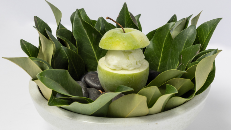 An apple dessert in a bowl with leaves