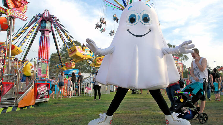 A person in a ghost costume at a carnival