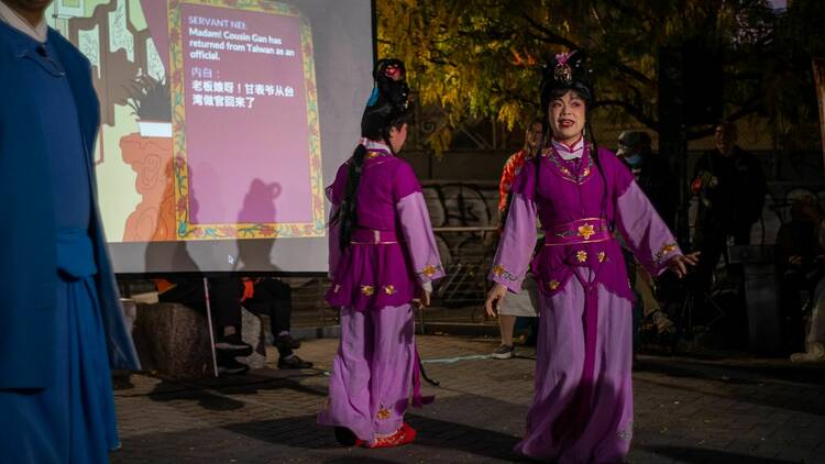 Women in purple outfits perform as part of the Eastern Fuzhou Opera Association 