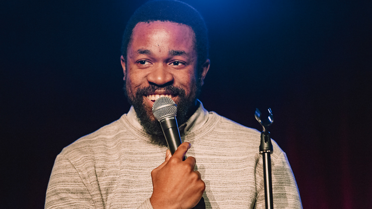 Ikechukwu Ufomadu holds a microphone. 