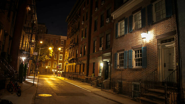 Red brick buildings in NYC illuminated by street lights.