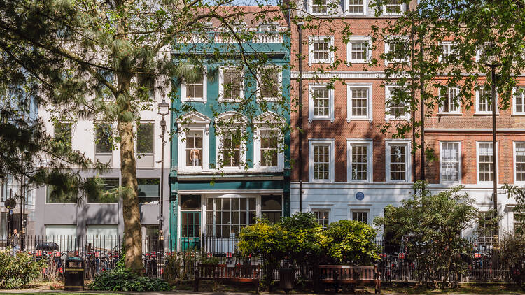 Teal exterior of a five-storey Soho Square townhouse 