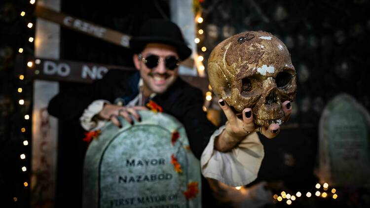Actor at Hallowed Peak holding skull