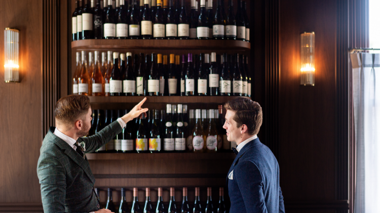 Two team members looking at the wine at Charlotte Bar and Bistro