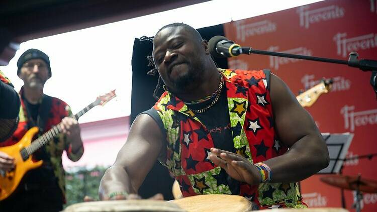 An African drummer performing on stage. 