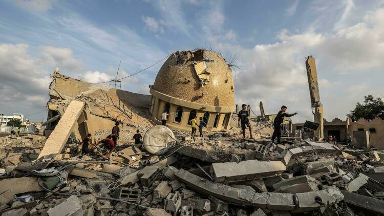 Palestinians inspect the ruins of a destroyed mosque in the city of Khan Yunis, south of the Gaza Strip