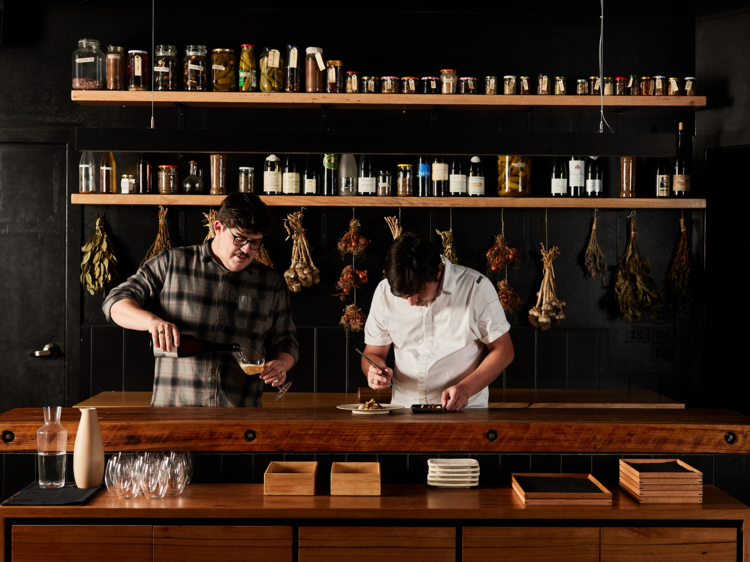 The Bertoncello brothers preparing food and drink behind the bar at O.My. 