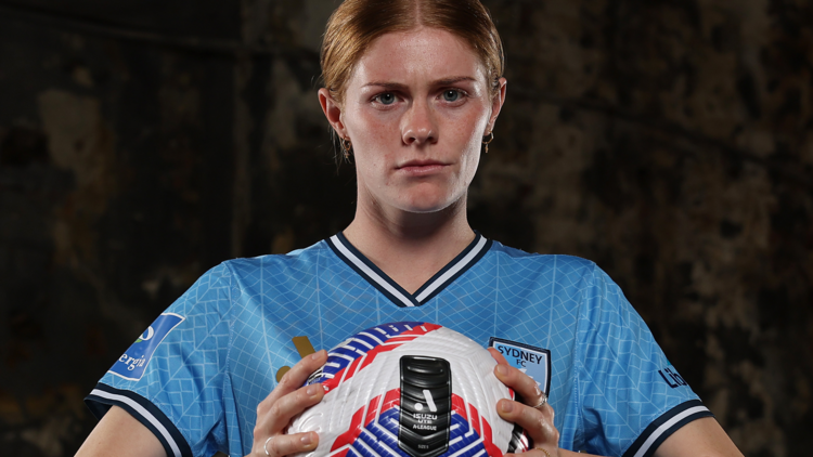 Cortnee Vine is holding a soccer ball