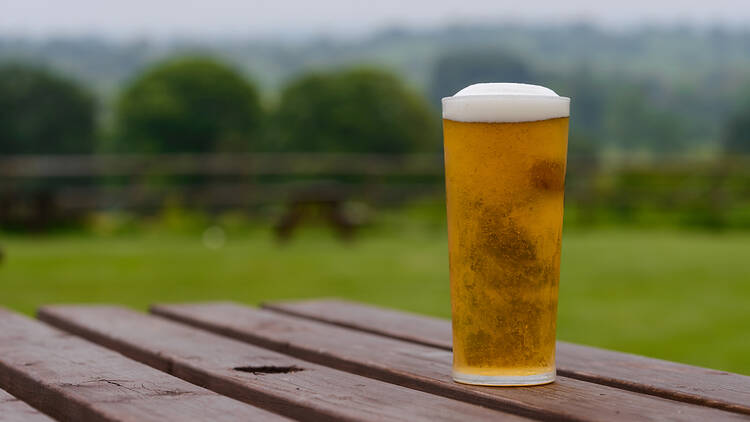 Pint of lager on a pub garden table