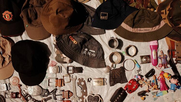 A table filled with hats and various trinkets.