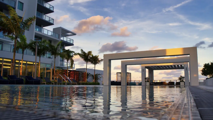 The outside of an apartment block in Miami, Florida, complete with a large outdoor pool.