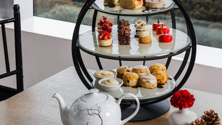 Fall tea service with orange leaves in the background.