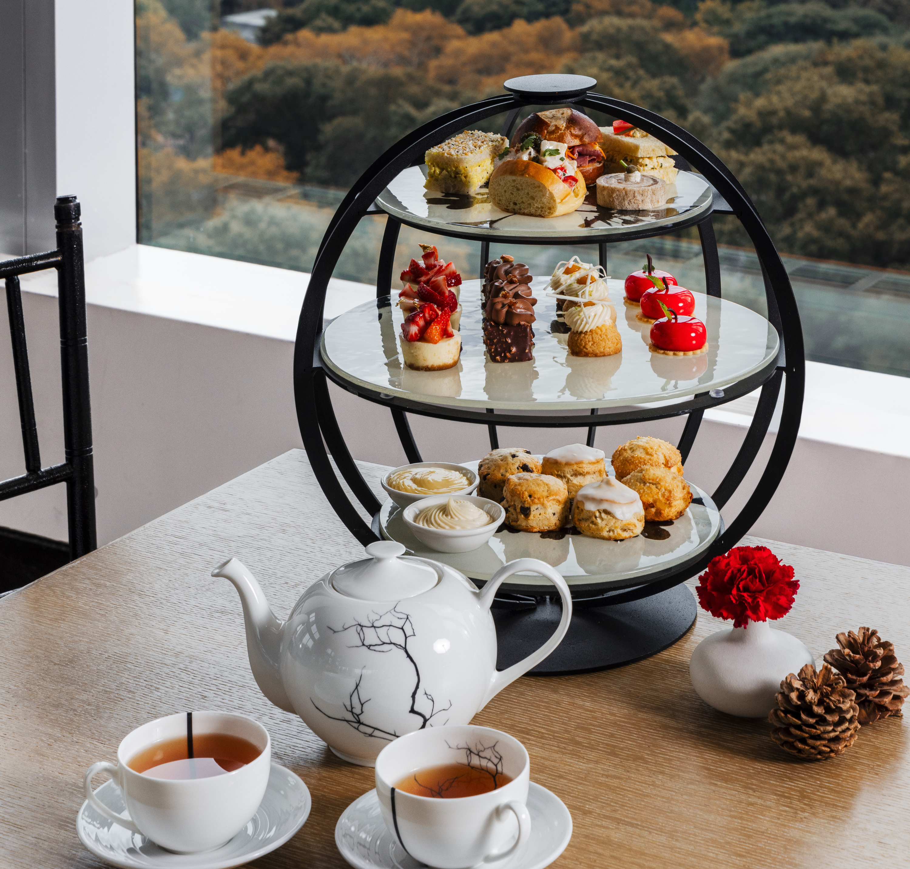 Fall tea service with orange leaves in the background.