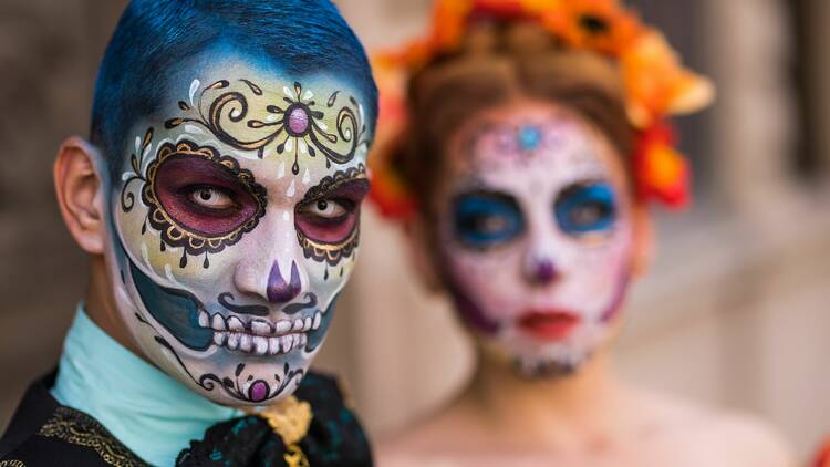 Revellers with their faces painted at a Day of the Dead celebration.