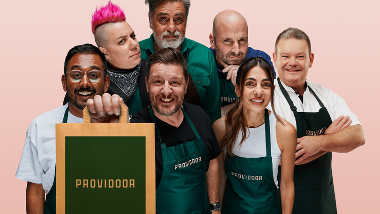 A group of famous Australian chefs in aprons holding a brown paper bag saying 'Providoor'.