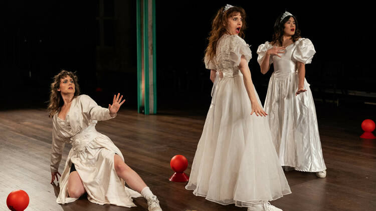 picture of three women wearing a wedding dress looking surprised