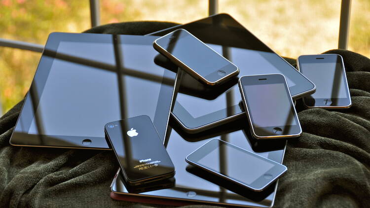 Pile of iphones and ipads.