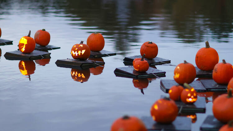 Jack-o-lanterns floating on the Harlem Meer.