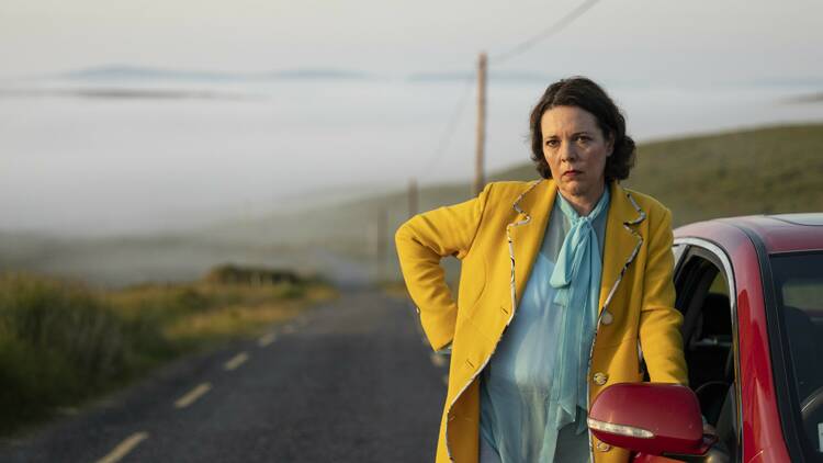 Picture of Olivia Coleman by a red car in the film 'Joyride'.