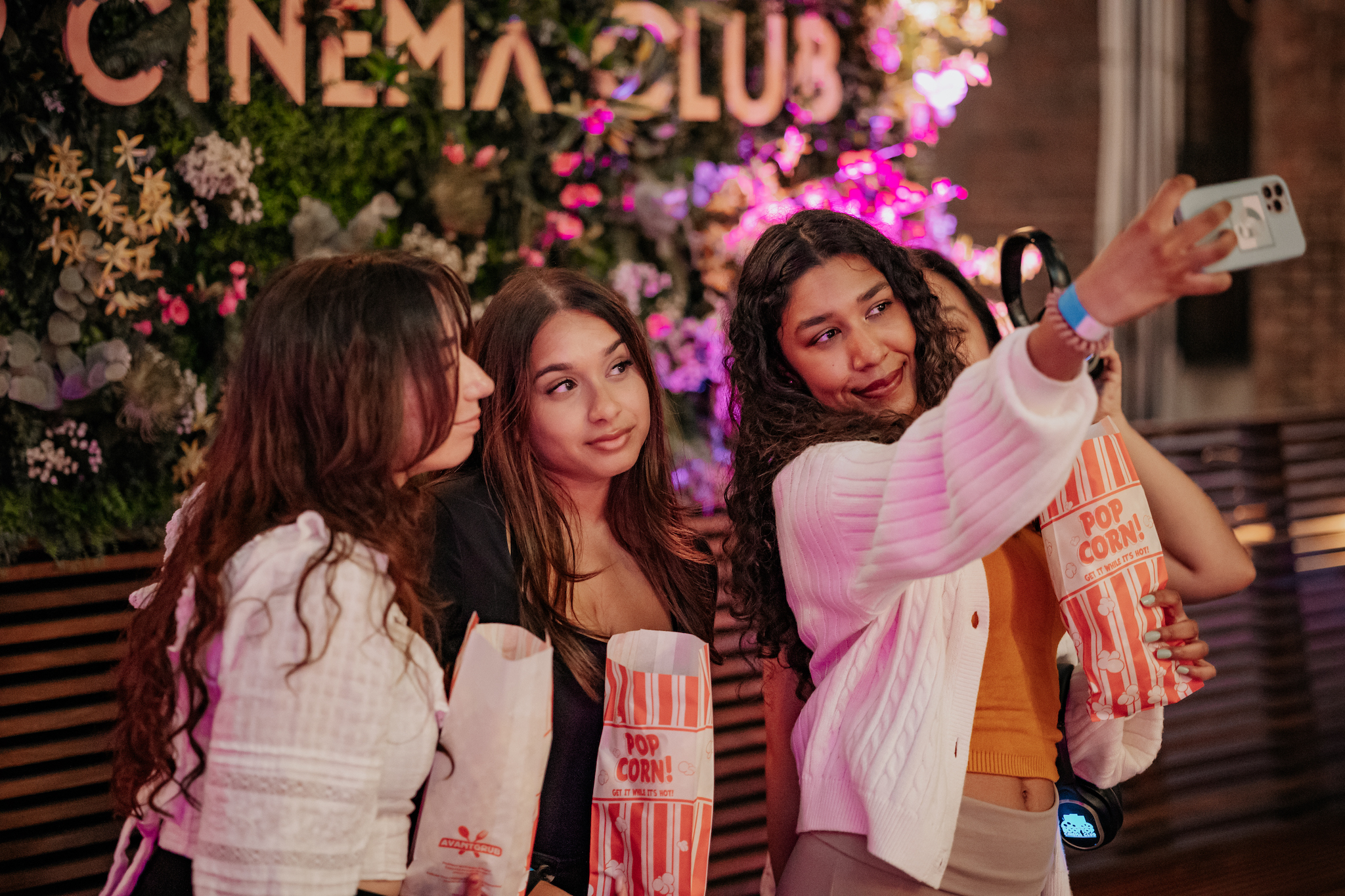 Three women take a selfie at Rooftop Cinema Club.