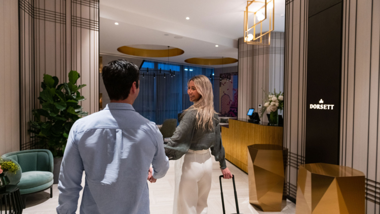 A couple arriving in the foyer of Dorsett Melbourne