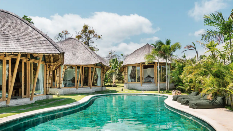 A rental estate in Bali with four comfortable bungalows , a shared swimming pool, cabana, and lush private gardens.