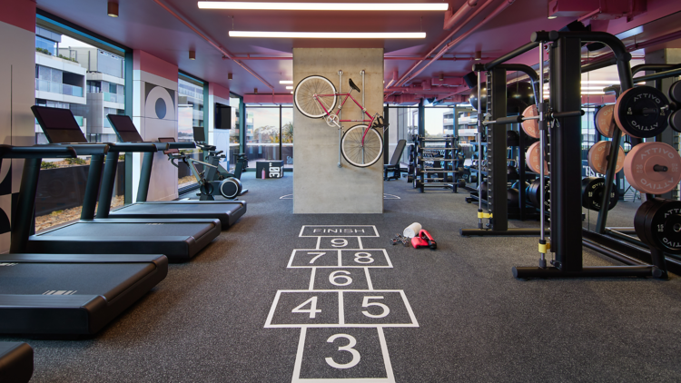 A gym with hop scotch and treadmills