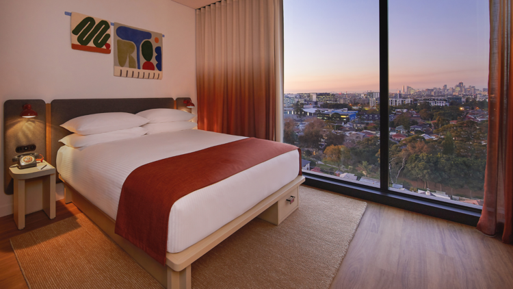 A double bed hotel room with city view