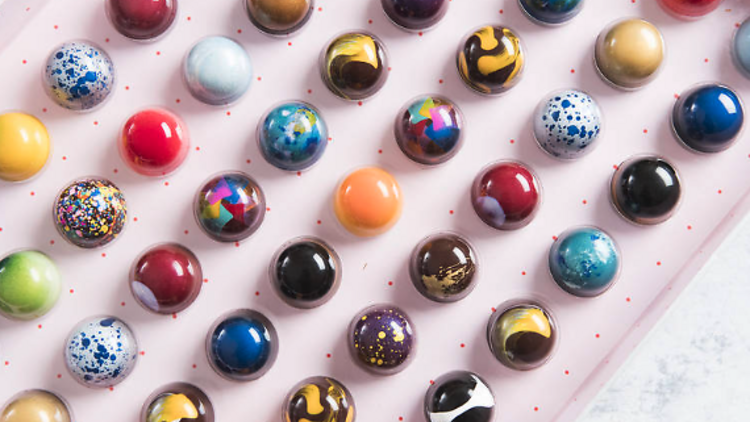 A large number of colourful glazed bon bon chocolates from Stick With Me Sweets.