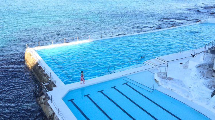 Girl walking beside pool