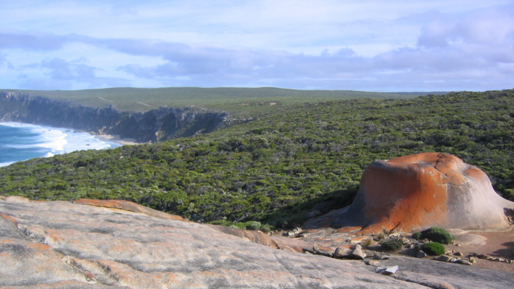 A view of coastline on Kangaroo Island with a prominent rock formation in the foreground